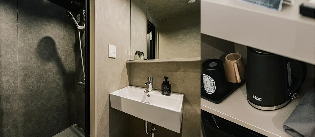 A picture of Bathroom that has wash basin, toilet and shower.